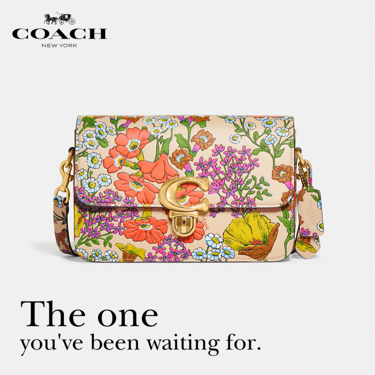 Floral print Coach purse sitting on white background