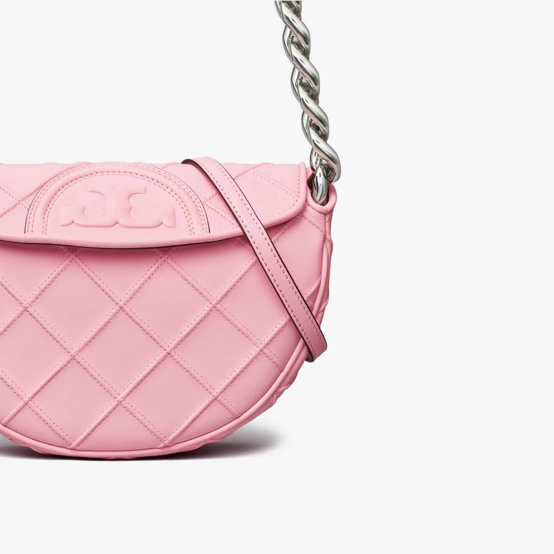Light pink hand bag against a white background