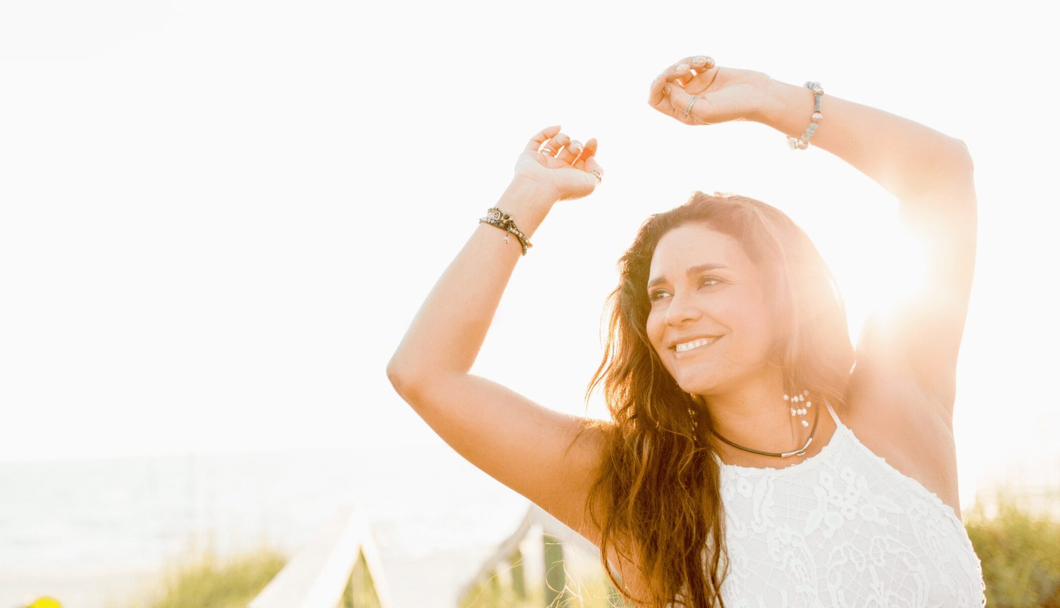 Happy woman standing in sunlight