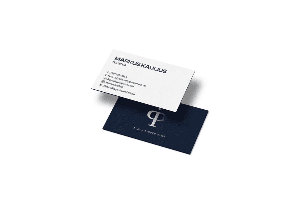 Business card designs for Play A Bigger Game shown on a white background
